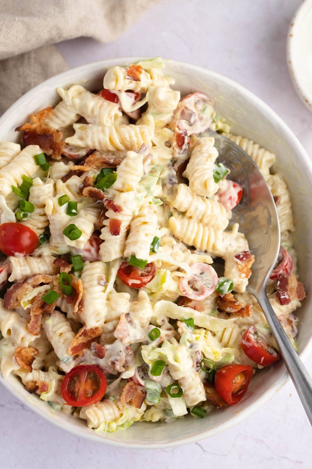Top View of a Bowl Serving of Homemade BLT Pasta Salad With Spoon