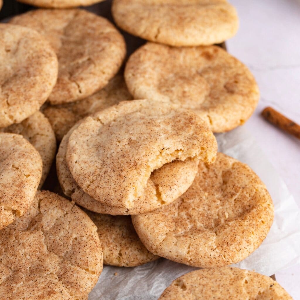 Chewy Cinnamon Cookies on a White Baking Sheet