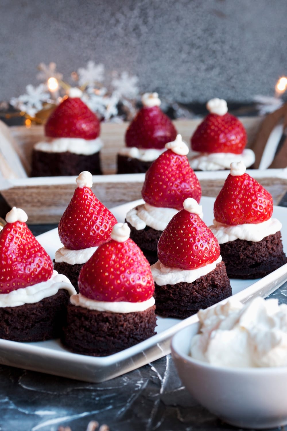 Strawberry Christmas hats made with chocolate brownies., ripe strawberries and whipped cream. 