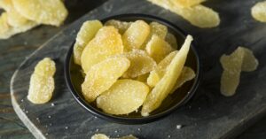 Crystalized Ginger with Sugar in a Black Container
