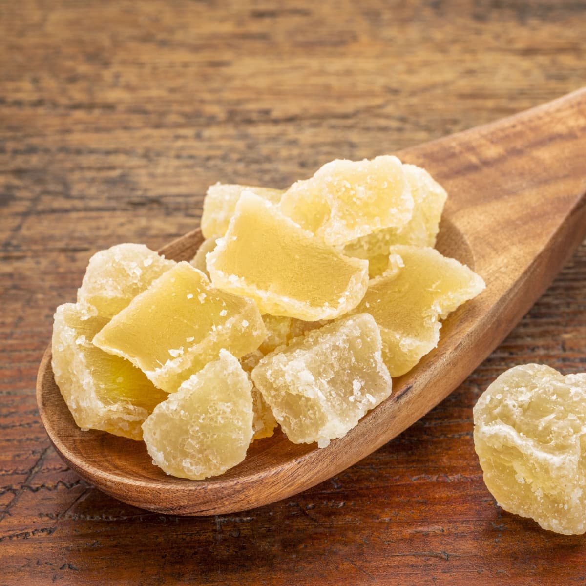 Chunks of Crystallized Ginger on a Wooden Spoon