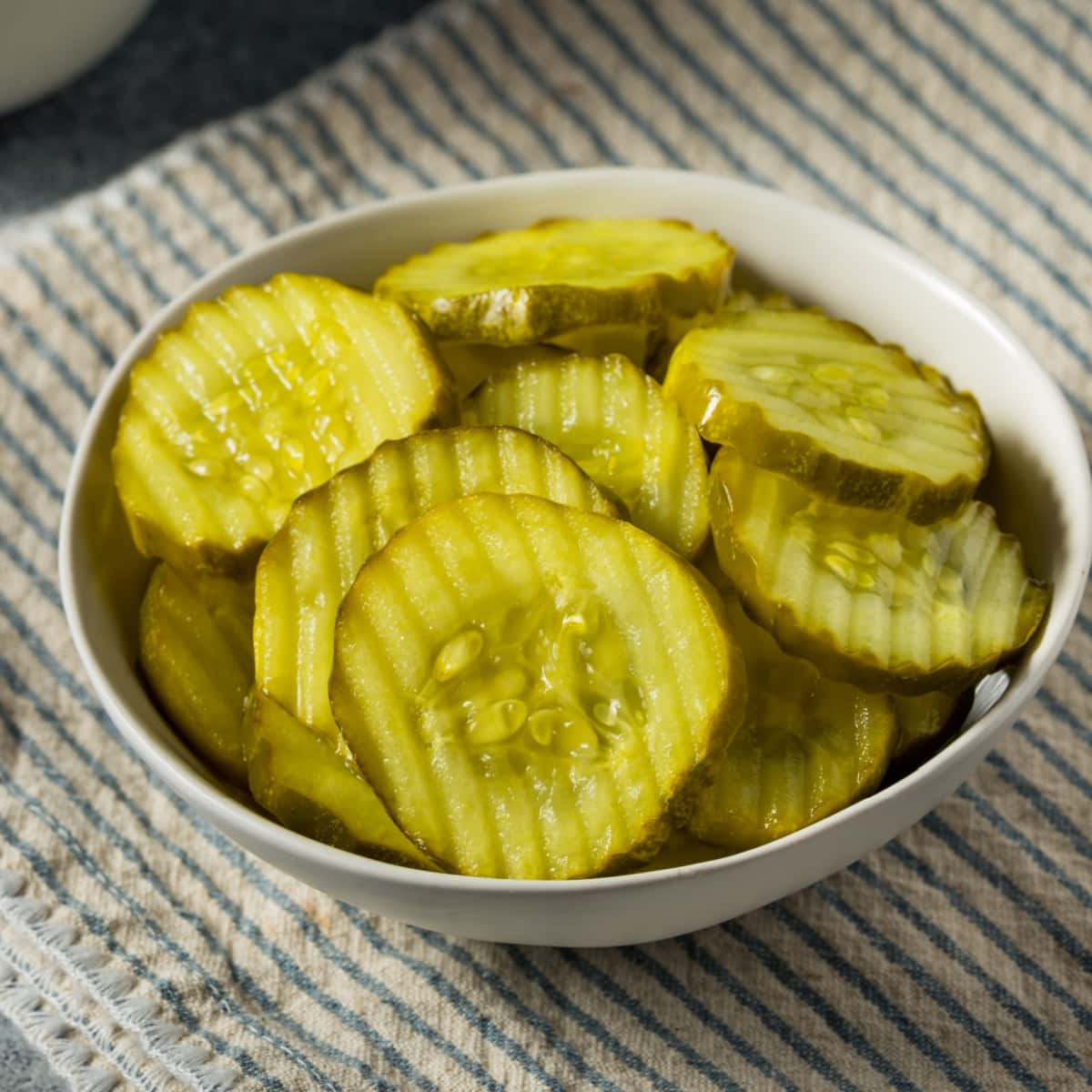Dill Pickle Slices in a White Bowl