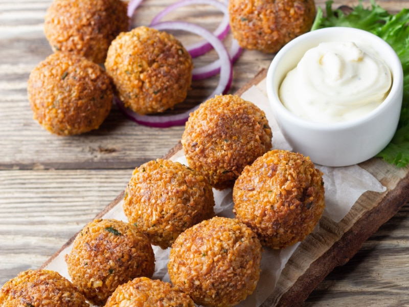 Falafel Balls on Wooden Board With White Sauce Dip