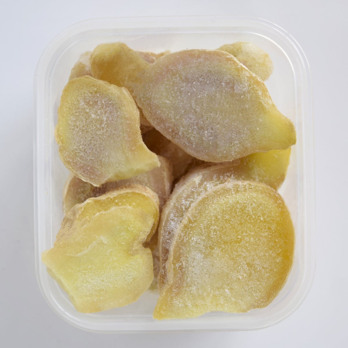 Chunks of Frozen Ginger in a Plastic Container
