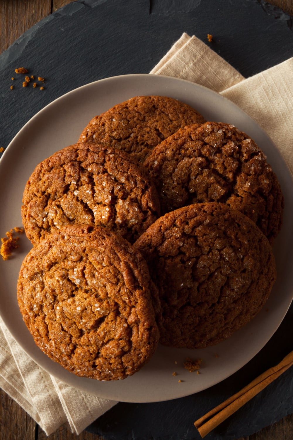 Four pieces of big ginger cookies on a plate. 