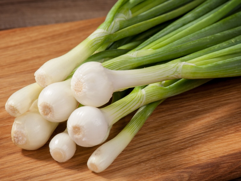 Green Onions on a Wooden Cutting Board