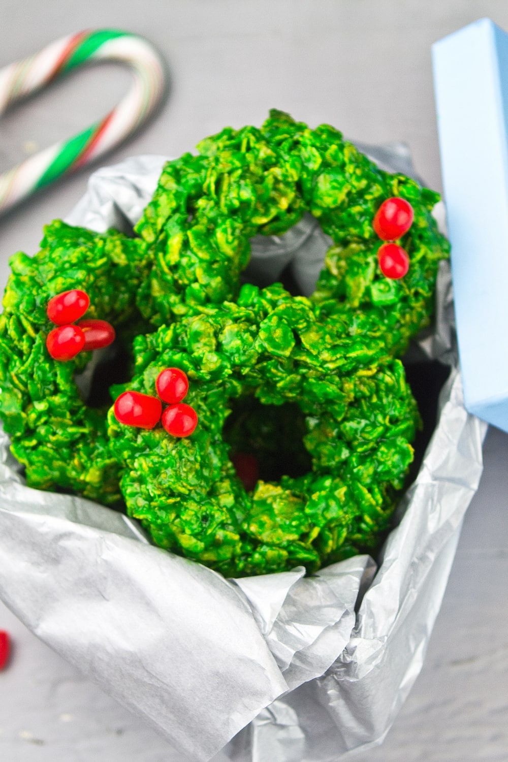 Green Colored Homemade No-Bake Christmas Wreath Cookies Made With Rice Crisps Garnished With Cherries