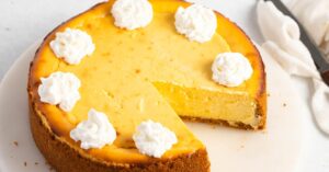 Homemade Sweet and Tangy Lemon Cheesecake with Heavy Whipped Cream