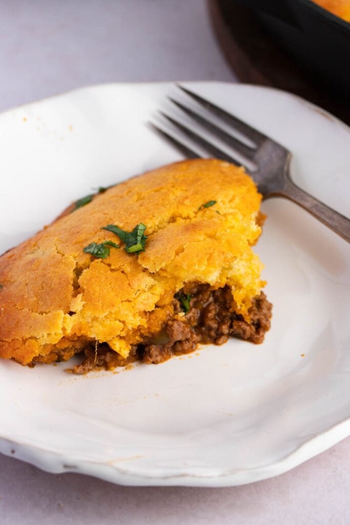 Homemade Tamale Pie with Ground Beef in a White Plate