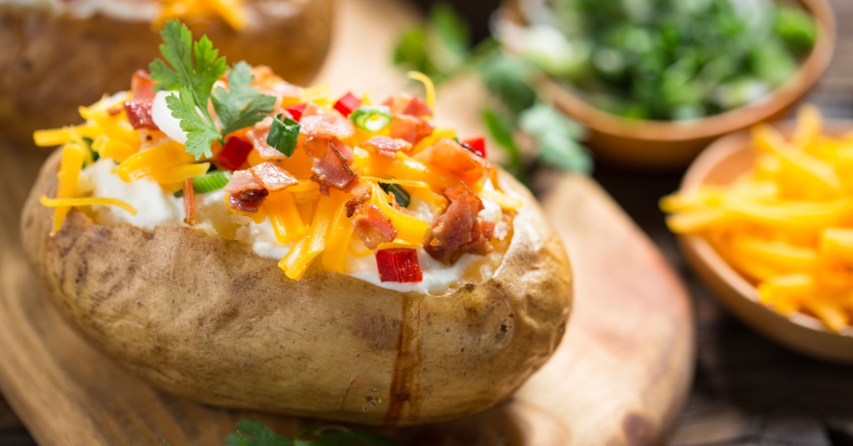 https://insanelygoodrecipes.com/wp-content/uploads/2023/04/Microwave-Baked-Potatoes-Topped-With-Cheese-and-Bacon.jpg