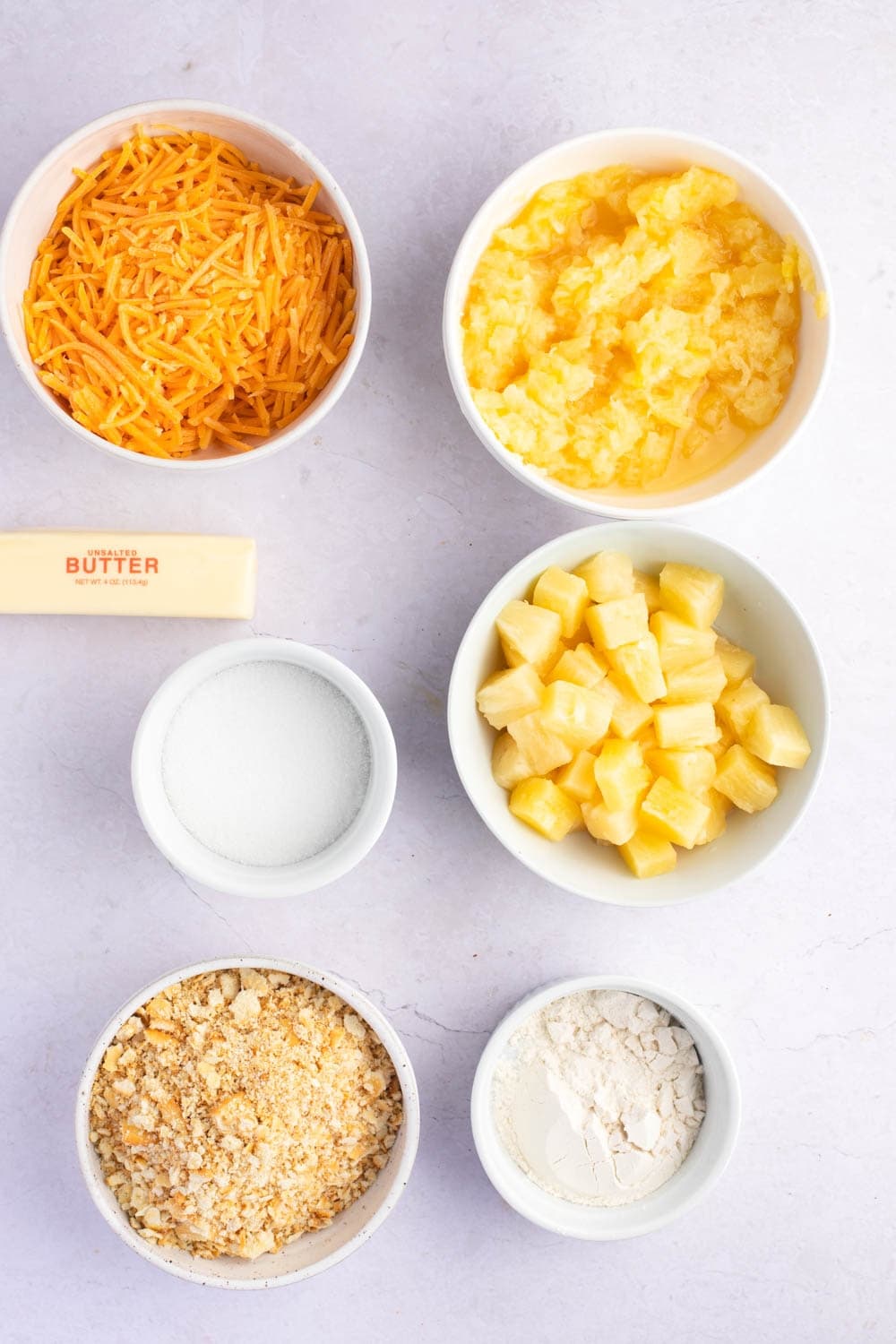 Pineapple Casserole Ingredients - Pineapple Chunks, Crushed Pineapple, Cheese, Sugar, Flour, Buttery Round Crackers and Butter