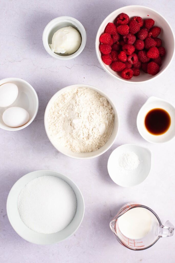 Raspberry Muffin Ingredients - Flour, Baking Powder, Shortening, Sugar, Eggs, Milk, Vanilla Extract and Raspberries
