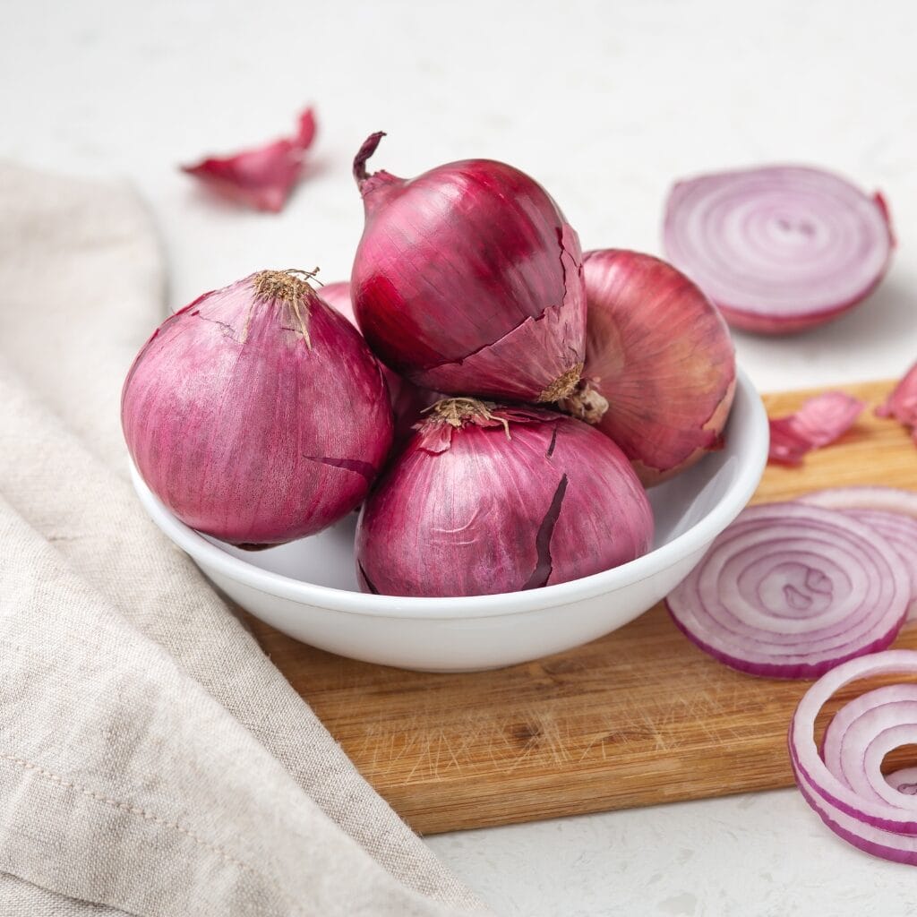 Raw Organic Purple Shallots in a White Bowl