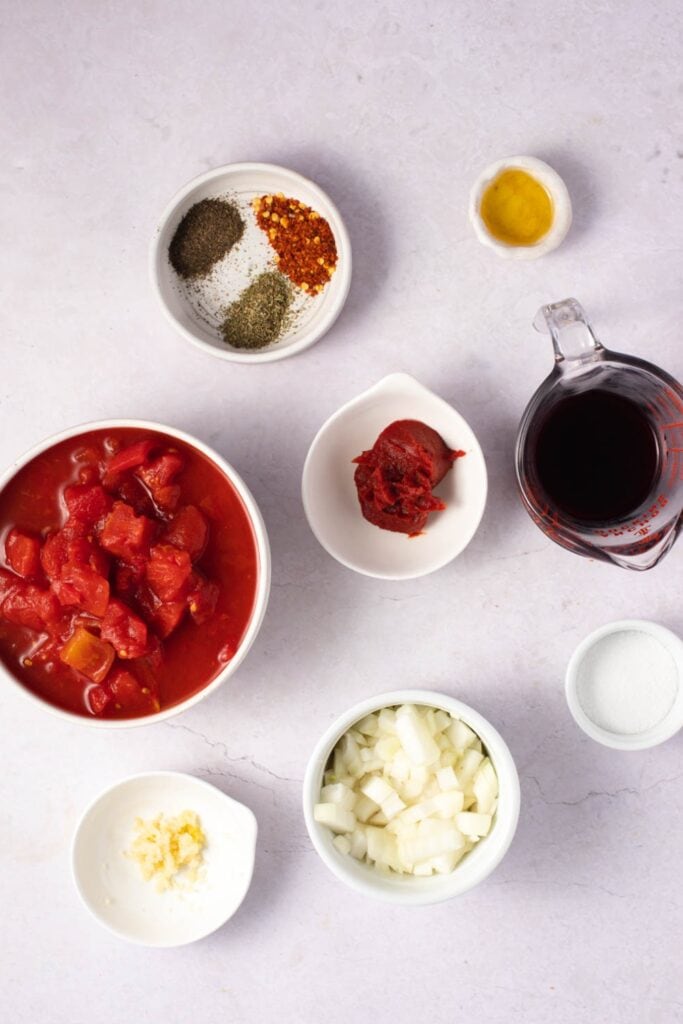Arrabbiata Sauce Ingredients - Olive Oil, Aromatics, Tomatoes, Red Wine, White Sugar, Herbs, Lemon Juice and Spices
