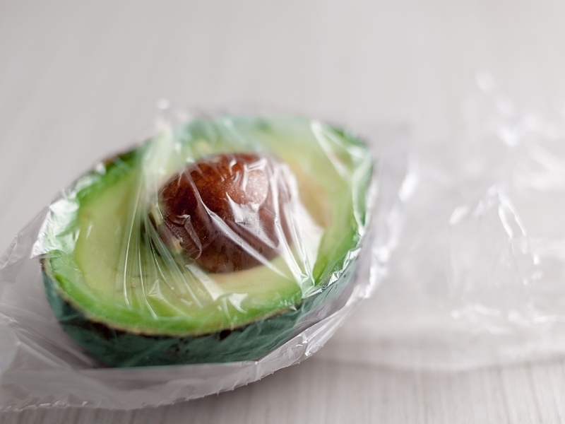 Avocado Sliced in Half Wrapped on a Plastic Bag