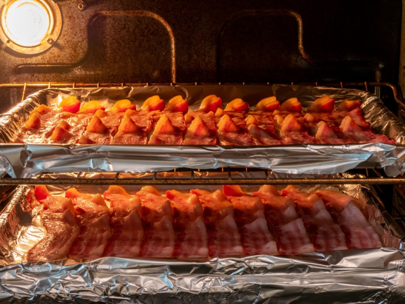 Two Pans of Bacon in an Oven