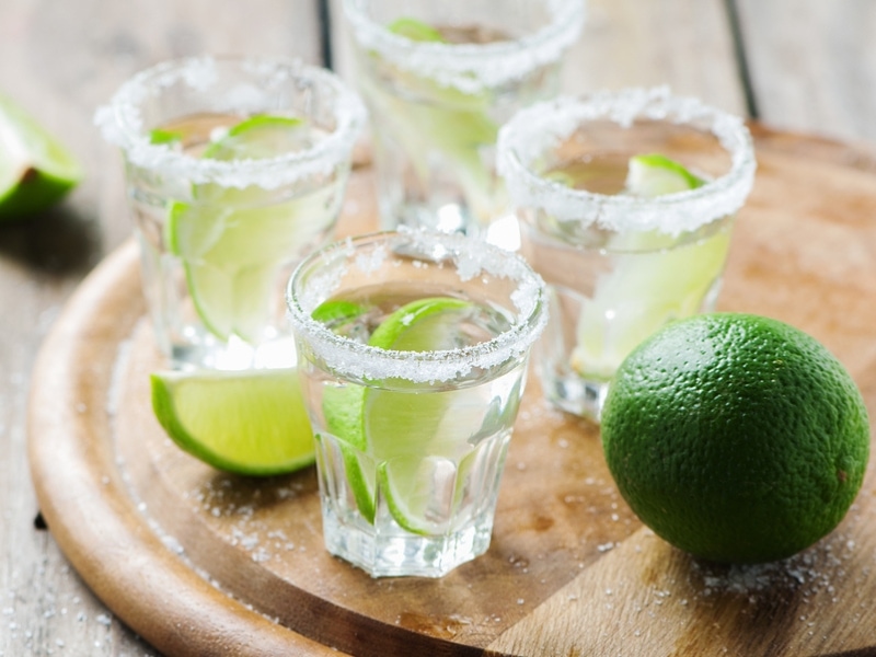 Four Shot Glasses of Blanco Tequila With Lime