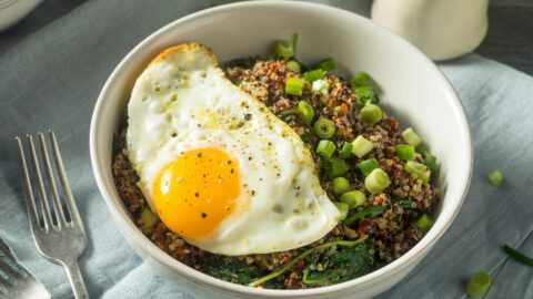 Bowl of Homemade Breakfast Quinoa with Onions and Egg