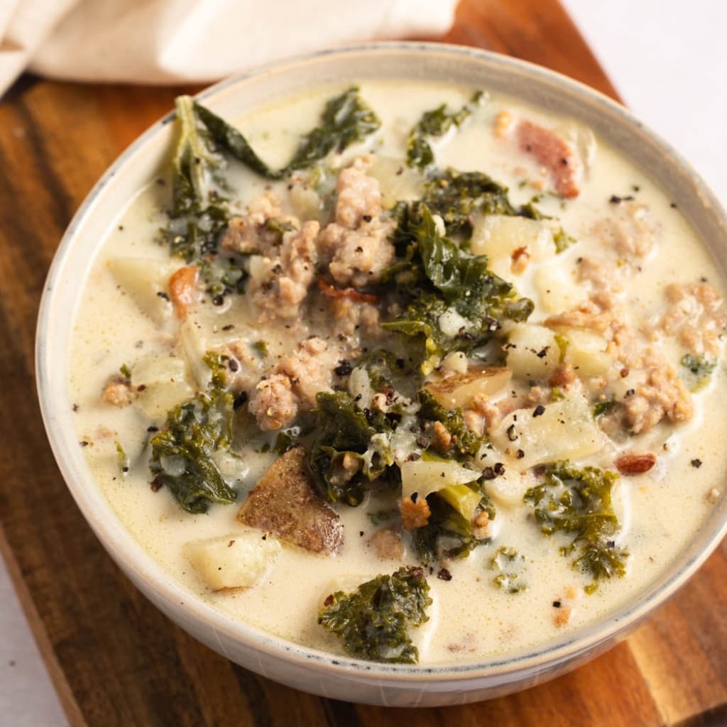 Bowl of Warm Homemade Zuppa Toscana Soup with Sausage, Bacon and Vegetables
