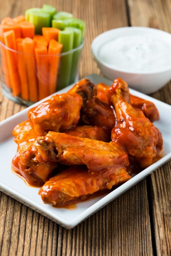 Buffalo Chicken Wings with Celery Sticks and Sauce