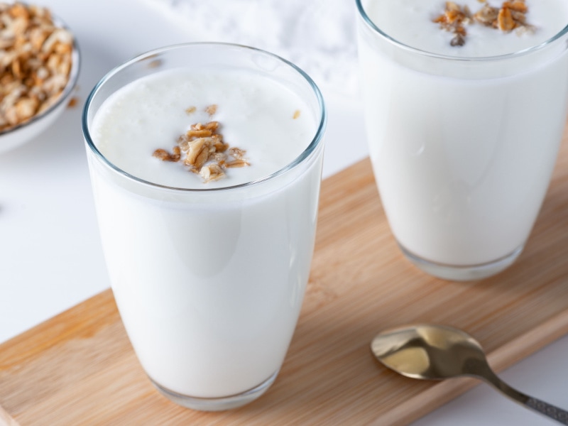 Two Glasses of Buttermilk With Granola Grains on Top