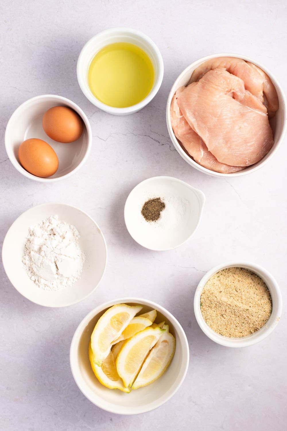 Chicken Milanese Ingredients - Flour, Eggs, Kosher Salt, Black Pepper, Breadcrumbs, Boneless Chicken, Vegetable Oil and Lemon
