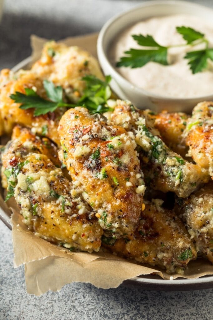 Chicken Wings Seasoned with Garlic Parmesan Sauce Garnished with Fresh Parsley