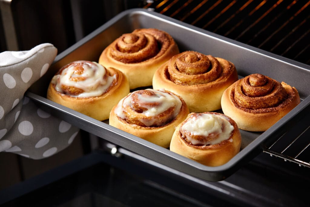 Cinnamon rolls getting reheated in the oven