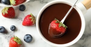 Dipping Strawberry in a Bowl of Melted Chocolate