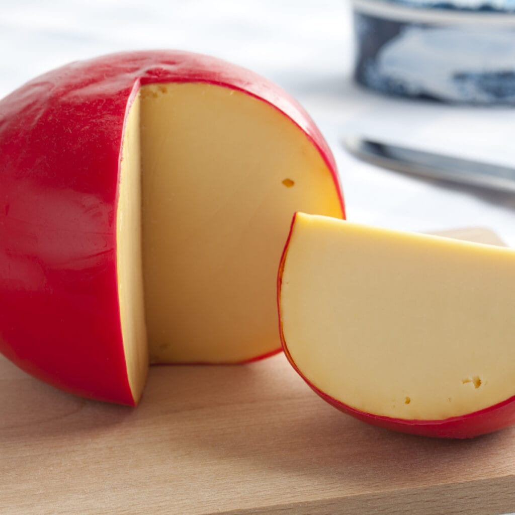 Sliced Edam Cheese on a Wooden Cutting Board