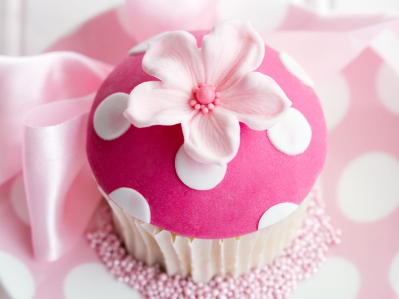 Cupcake Decorated With Pink Polka Dot Fondant and Pink Fondant Flower