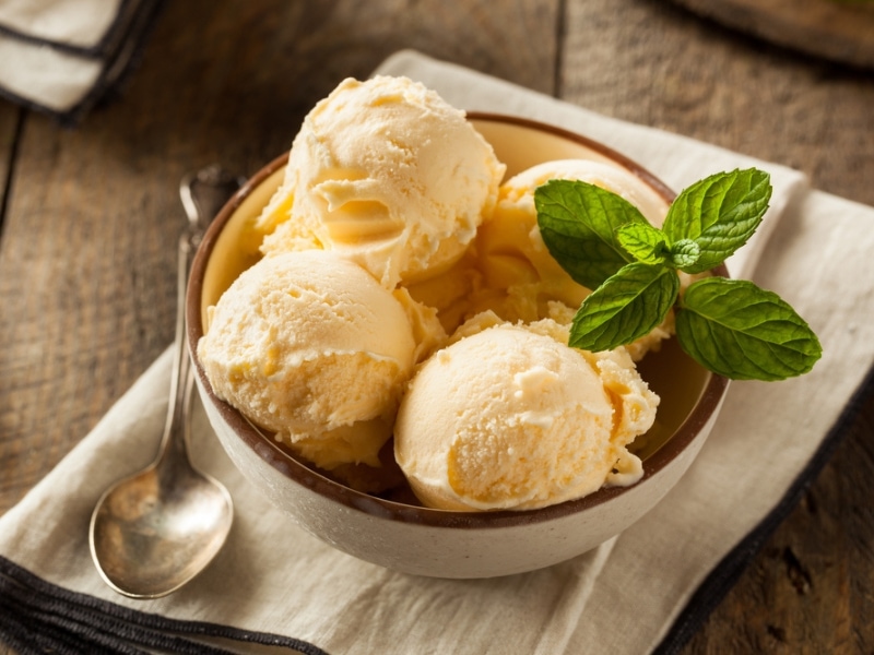French Vanilla Ice Cream Scoop in a Bowl Garnished with Fresh Mint Leaves