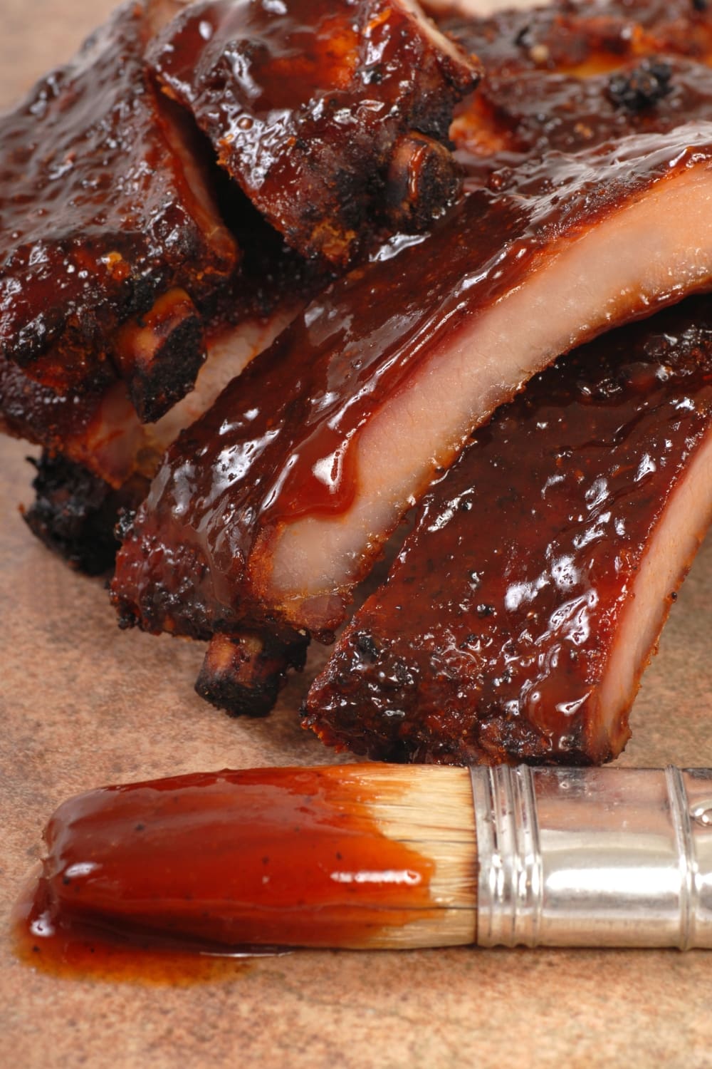 How to Make Ribs in the Oven featuring Homemade Baby Back Ribs with Sauce and Sauce Brush with Barbecue Sauce