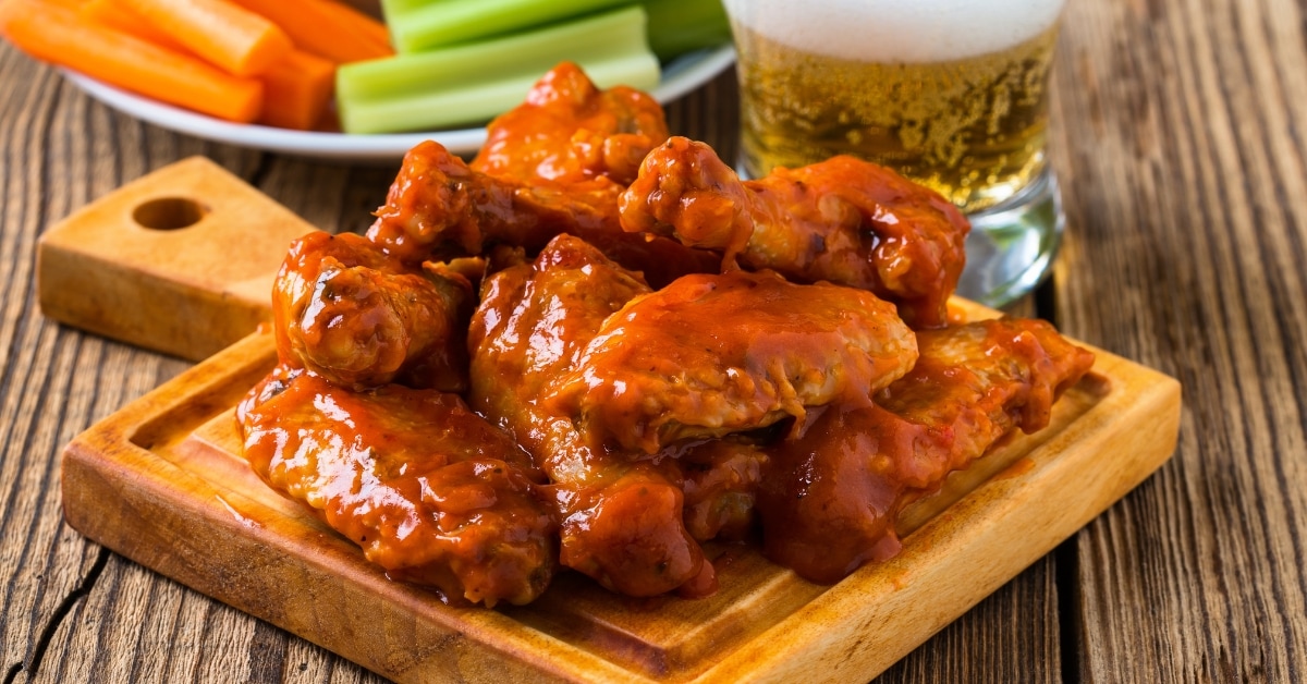 Homemade Buffalo Chicken Wings with Celery Sticks and Beer