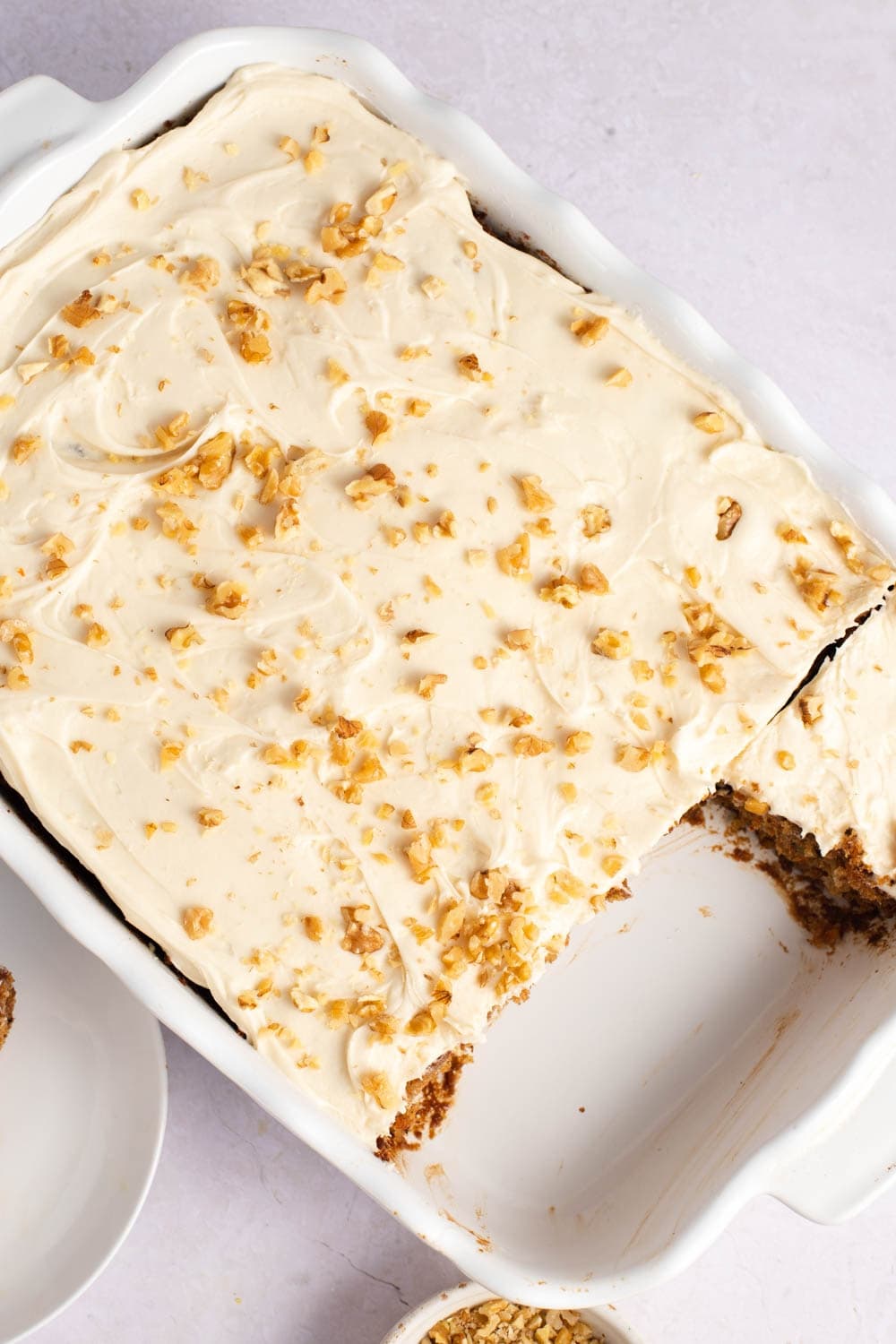 Carrot Cake with cream frosting and chopped walnuts.