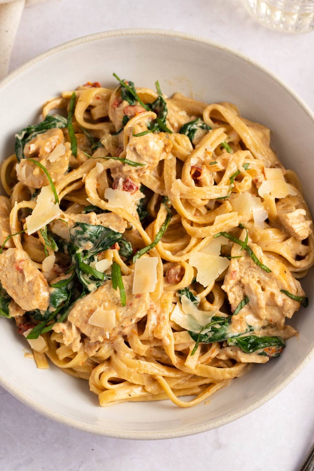 Chicken Florentine Pasta with sun-dried tomates, spinach, and Parmesan cheese.