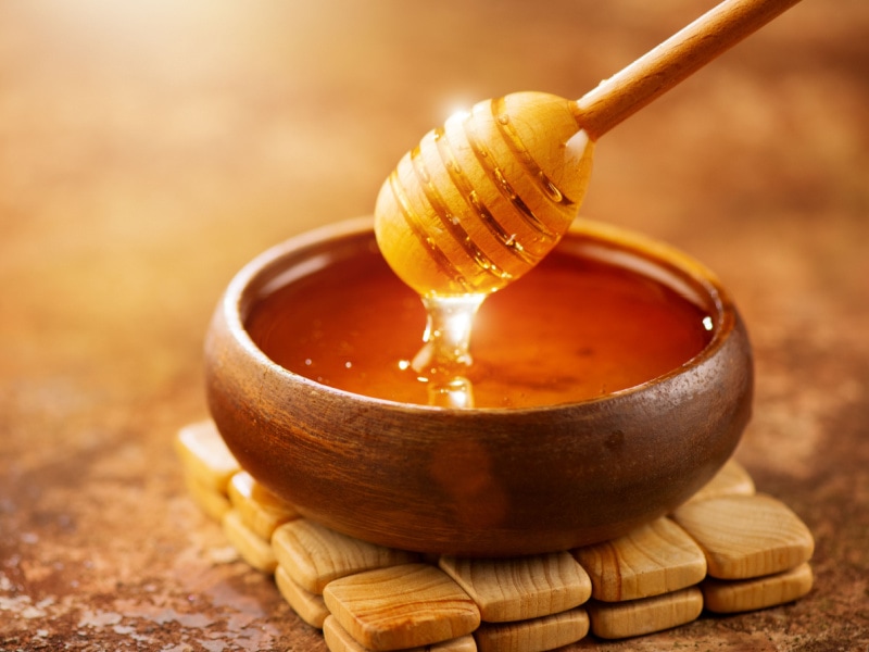 Dripping Honey on a Wooden Bowl