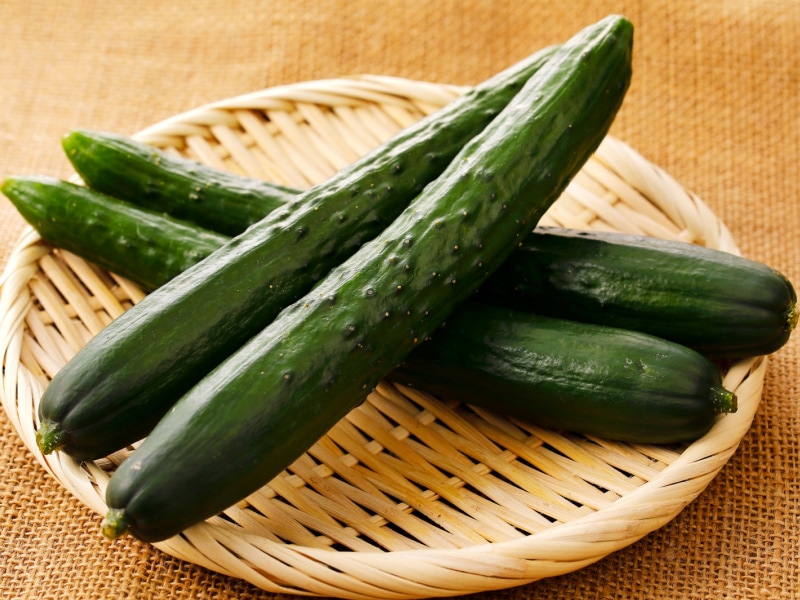 Four Japanese Cucumbers on a Bamboo Basket