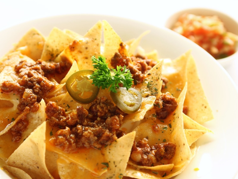 Nachos With Ground Beef Toppings and Sliced Pickles