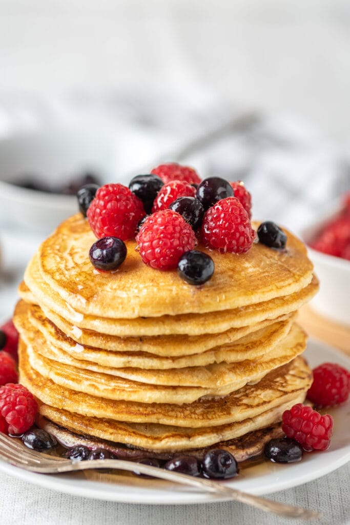 Stack of Homemade Pancakes Topped With Fresh Berries