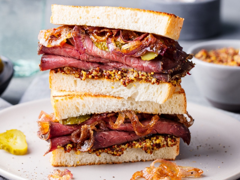 Pastrami Sandwich with Pickles on a Plate