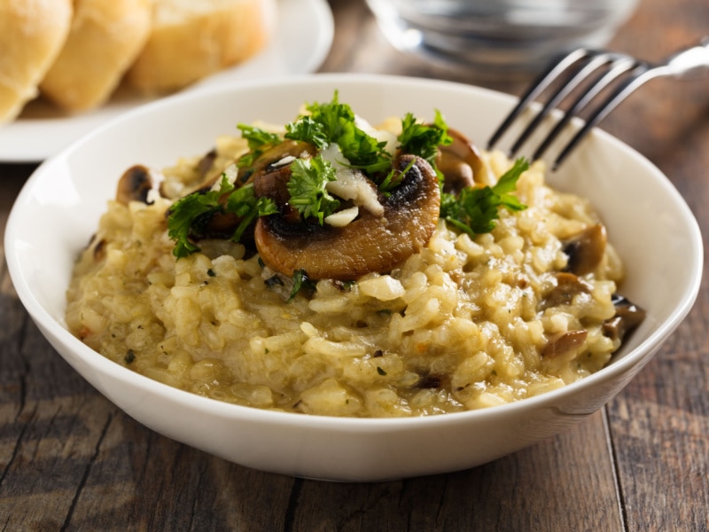 Risotto Mushroom in a White Bowl Garnished With Fresh Parsley on Top