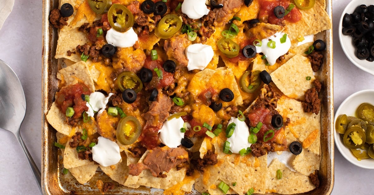 Savory Super Nachos with Sour Cream, Black Olives, Jalapenos and Ground Beef
