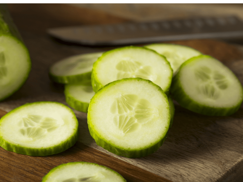 Slices of English Cucumbers on a Wooden Cutting Board