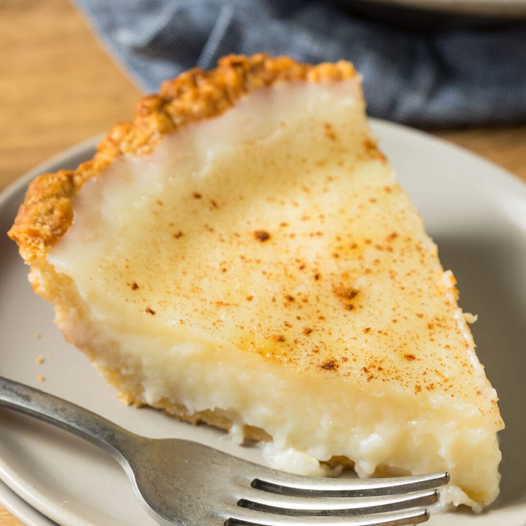 Slice of Sweet Amish Sugar Cream Pie Served on a Plate