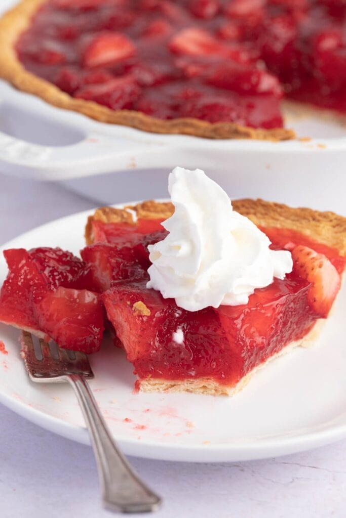 Sliced Homemade Strawberry Pie with Whipped Cream