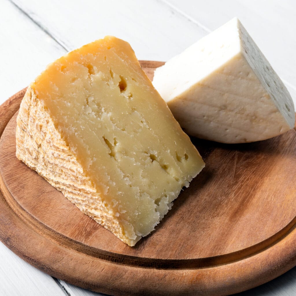 Chunks of Pecorino Cheese on a Wooden Cutting Board