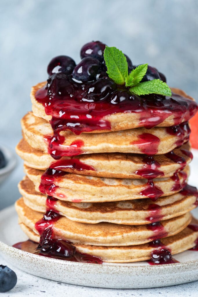 Stack of Pancake Topped With Blueberry Compote Dripping Sauce