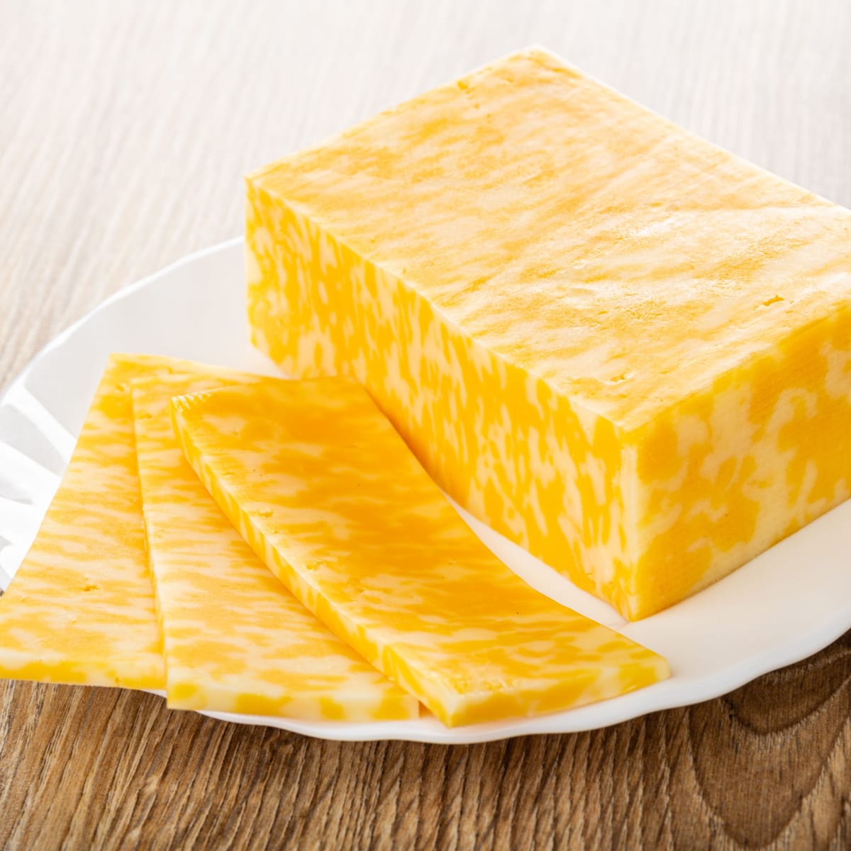 Slices of Unaged Monterey Jack on a White Plate