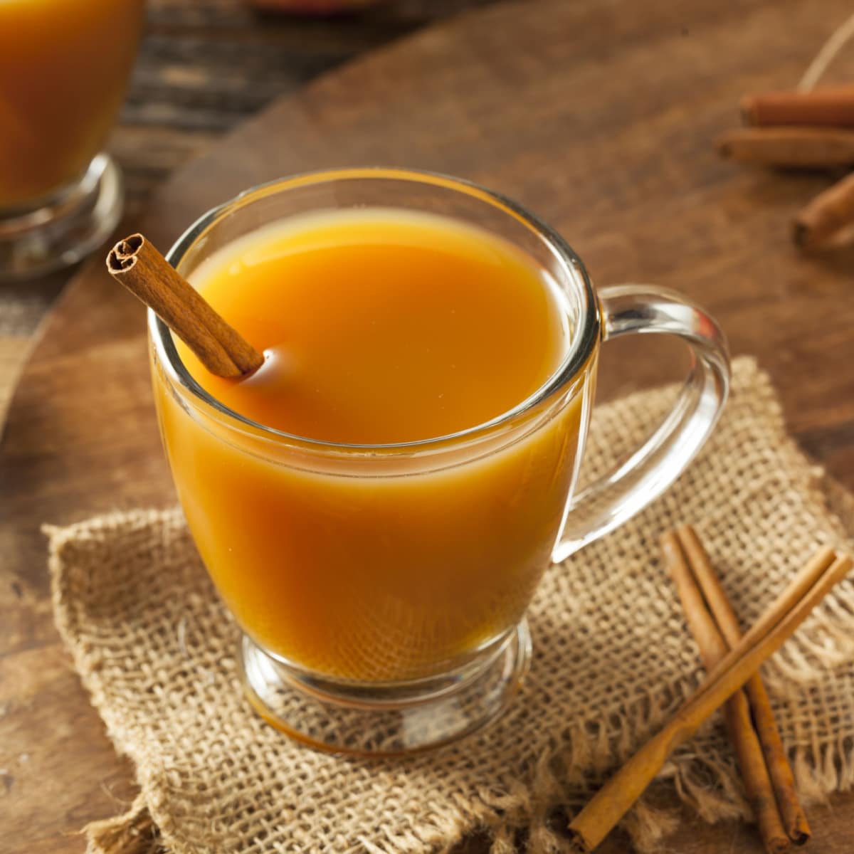 Warm Apple Cider on a Glass With Cinnamon